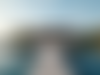 Eye-level view of luxury waterfront home with a private dock