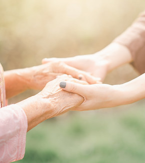 hand of an elderly lad being held by the hands of a younger woman. lasting power of attorney