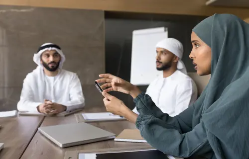 3 leaders discussing work during a meeting