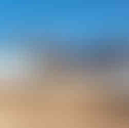 A steel structure on a concrete foundation with a blue sky in the background.