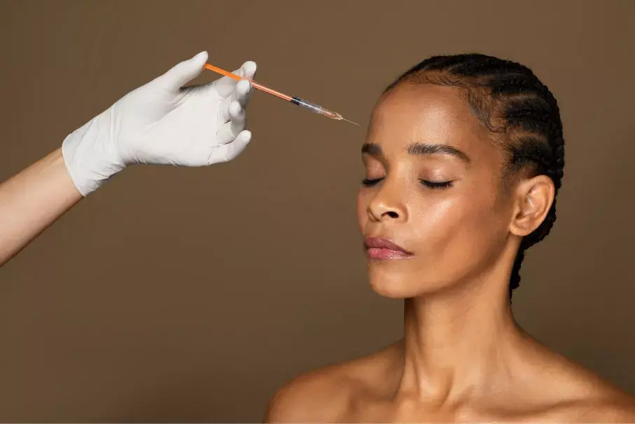 Close-up view of a syringe with dermal filler solution on a clean white surface