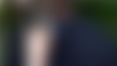 A t-shirt with a QR code on and someone is scanning the QR code with their phone.