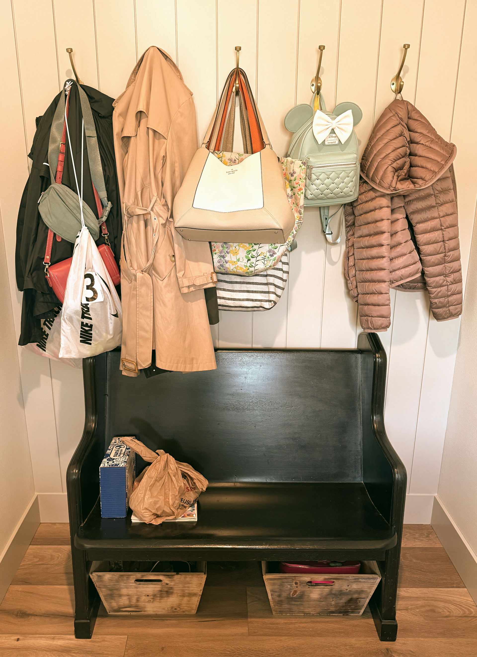 Mudroom with bench, hooks with coat and backpacks hanging