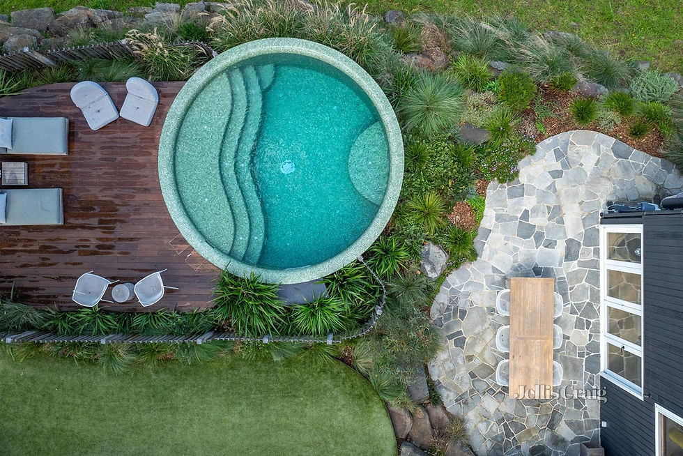 An overhead view of a landscaped garden with circular pool and crazy-paved outdoor entertaining area