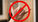 Hang 10 hand sign with a red line through it 
