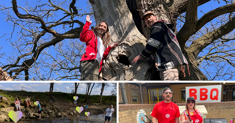 Simon and Matt are in a large tree with bare branches, they are waving and smiling, children are playing in a river and two people wearing red and black caps are holding tongs in front of a sign that says BBQ