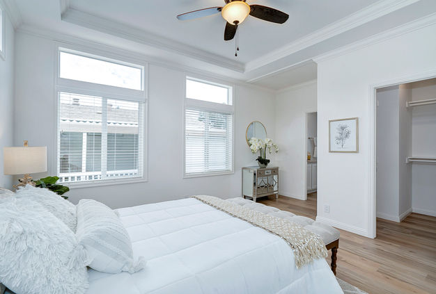 Bright bedroom with large windows, walk-in closet
