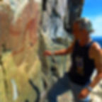 Zhaawano Giizhik offering asemaa (tobacco) to the spirit of Mishibizhiw atat Agawa Rock, Lake Superior.