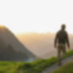 mature-man-walks-through-alpine-field-at-sunrise_edited.jpg