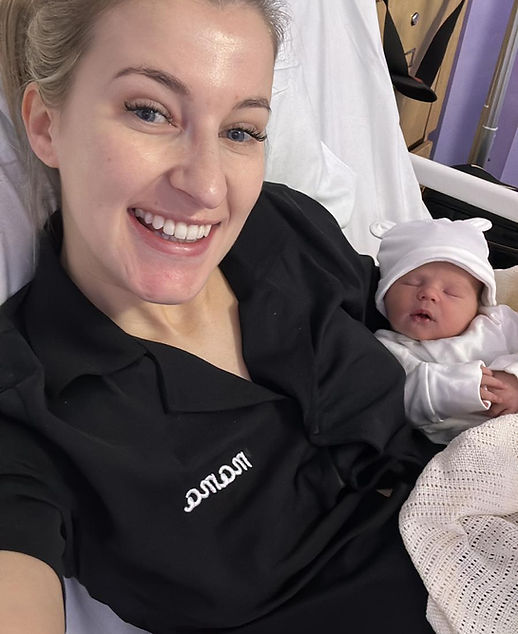 Mum holding her newborn baby on her chest