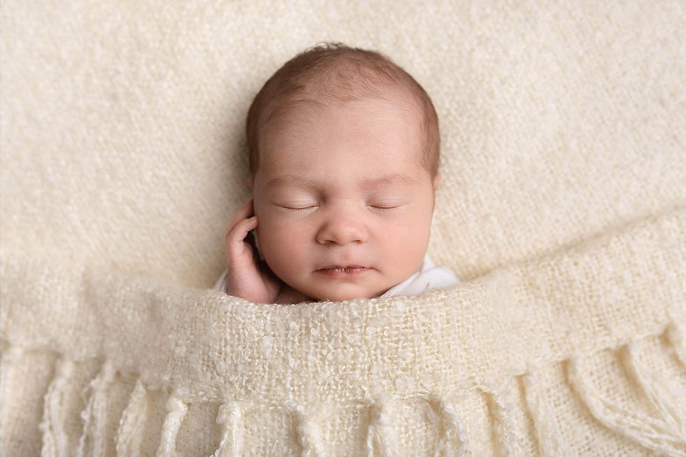New born baby sleeping with her hand on her face