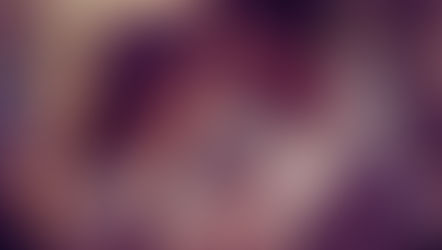 Smiling couple holding hands and touching foreheads.