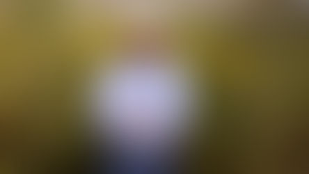 Man in cowboy hat standing in front of verdant forage