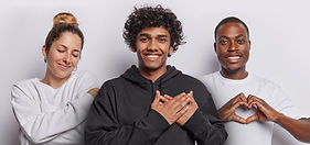 Gentle European woman keeps eyes closed smiles nd embraces own body Hindu man presses hand