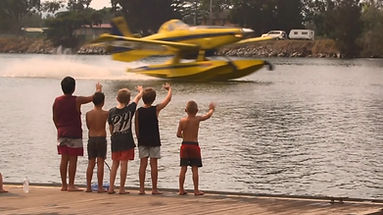 Kids waving at airtractor fireboss