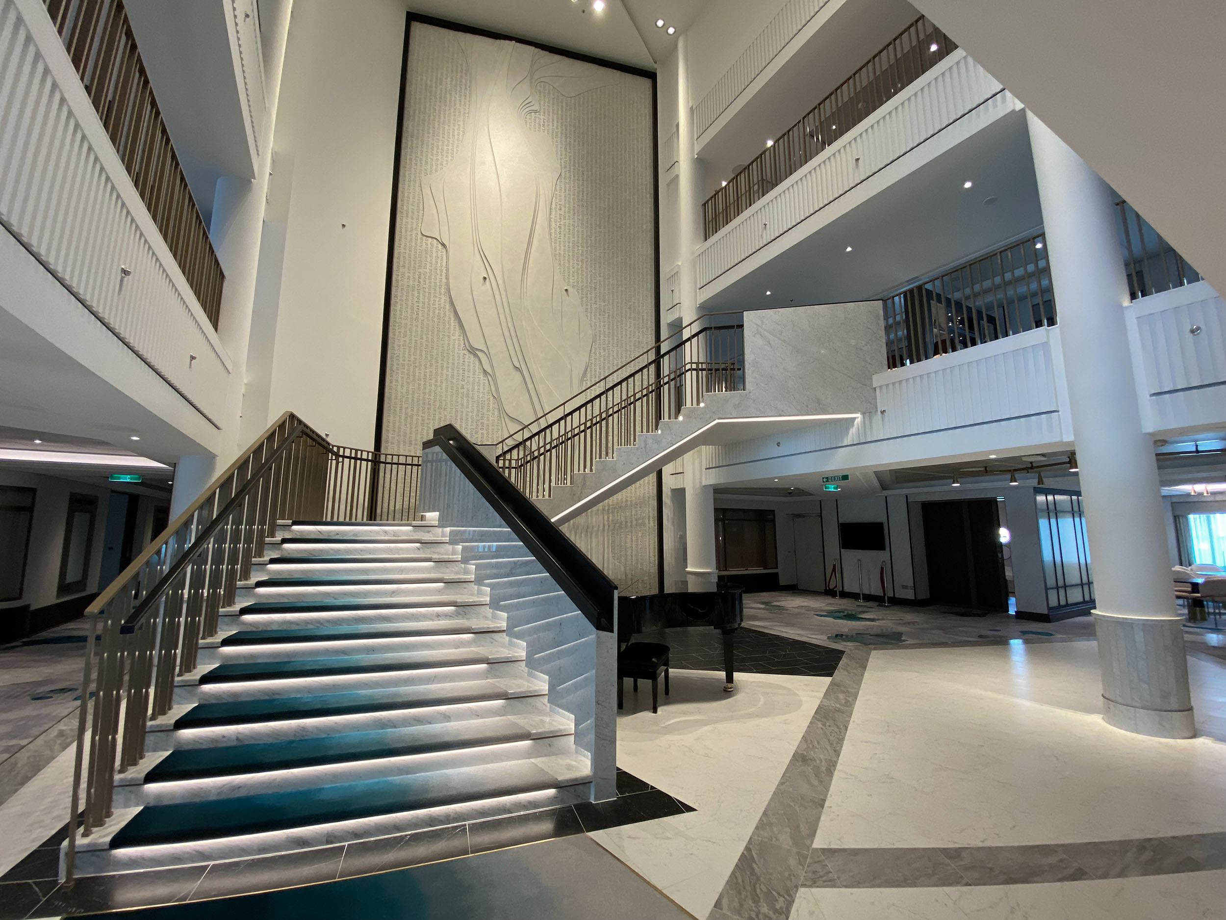 Contour stone relief sculpture spanning a cruise ship atrium wall