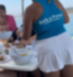 A photo of our charter manager Maria pouring guests a glass of champagne