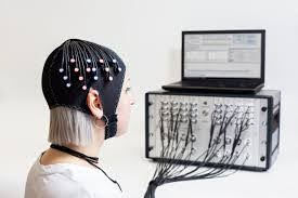 Courtesy of Wikipedia; a woman wearing an fNIRS headset connected to a Gowerlabs NTS system