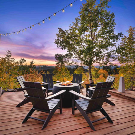 Airbnb deck  with fire pit at twilight in the fall