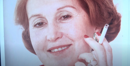 A photograph of Diop's grandmother, a glamourous woman with curled red hair and a cigarette in her hand, she is smiling