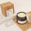 Thumbnail: amber glass double wood wick  soy candle scented with cedarwood essential oil. gift box tag ribbon box with next to it