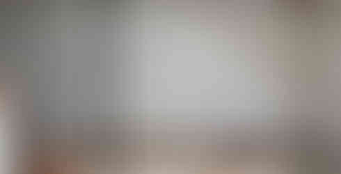 a white wall showing a green laser level setting out for wall panelling 