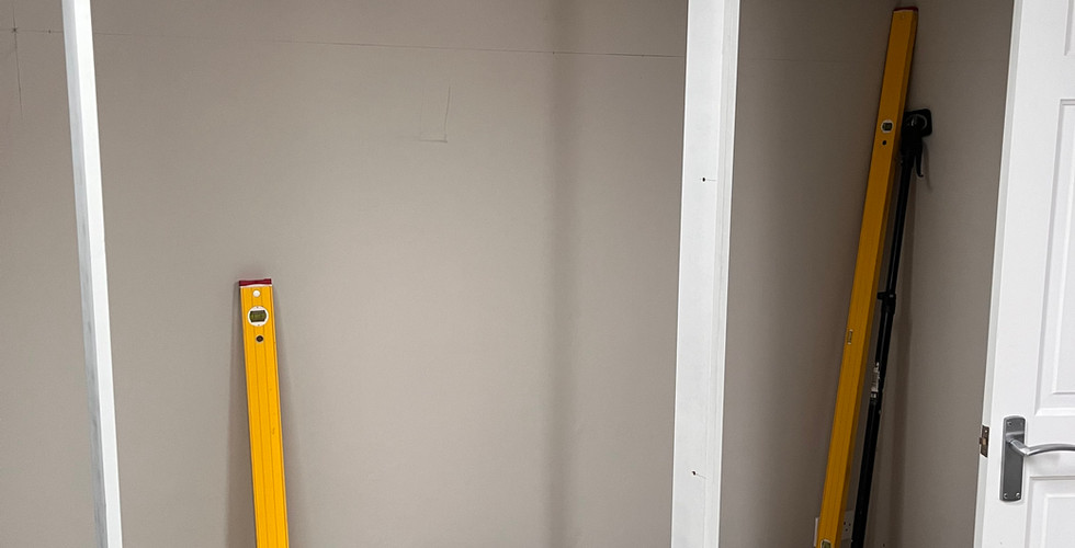 white framework being built to house shaker style wardrobe doors 