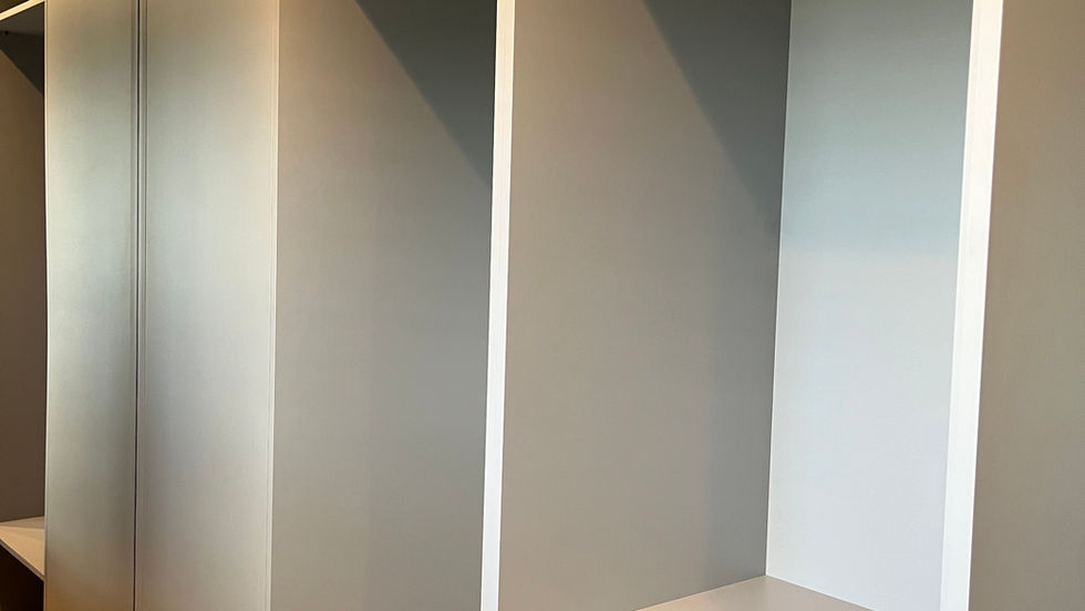 fitted wardrobes in a grey colour with hanging rails and shelves