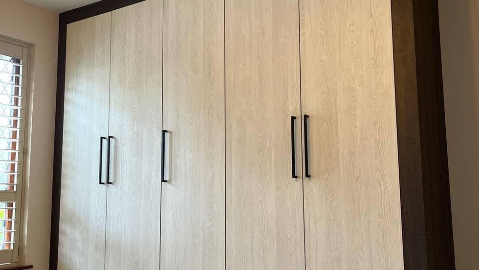 wardrobes with wood grain doors and black handles