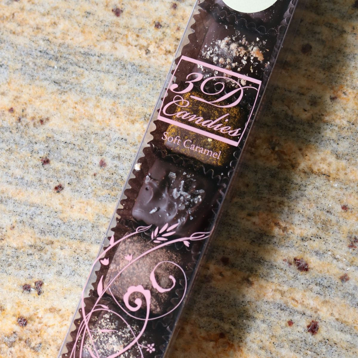 Keto Friendly Assorted Flavors of Caramel Candy, 7 pieces, sitting in their clear product box on a granite counter background