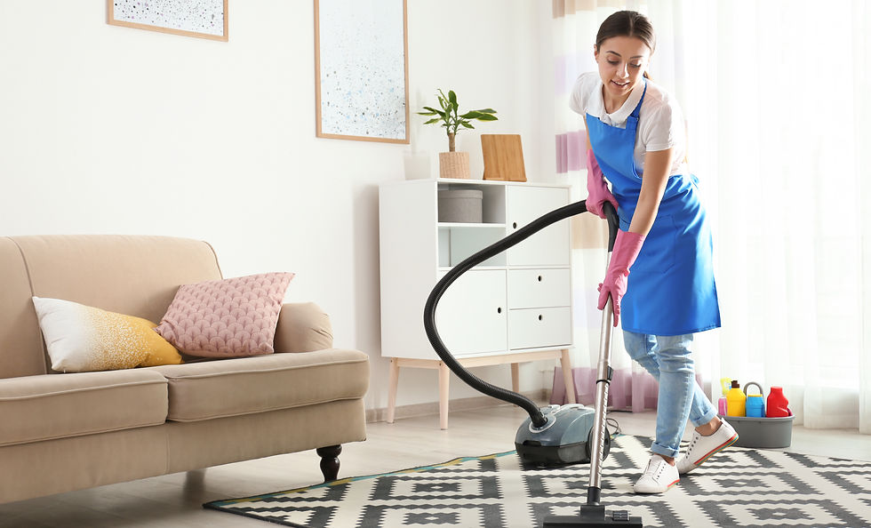 Woman hoovering carpet in living room. Cleaning service.jpg