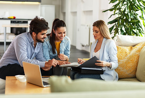 Female Real Estate agent offer home ownership and life insurance to young couple..jpg