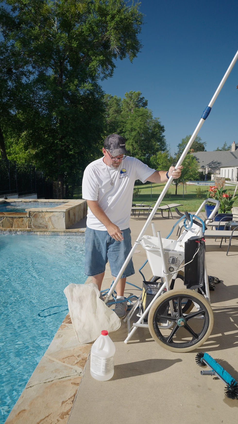 Superior Pools and Patios technician prepping pool cleaning equipment