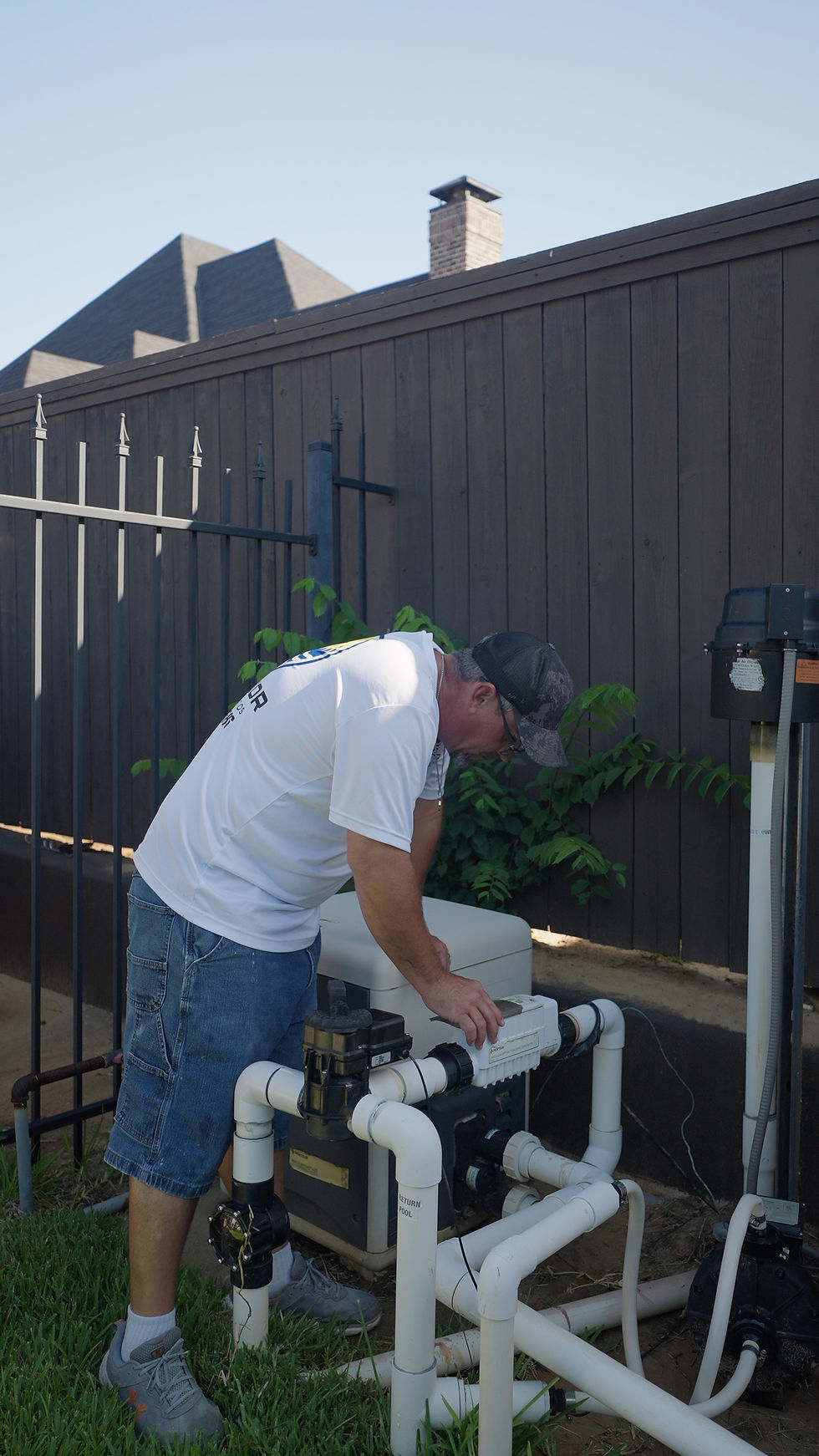 Superior Pools and Patios tech checking water pumps