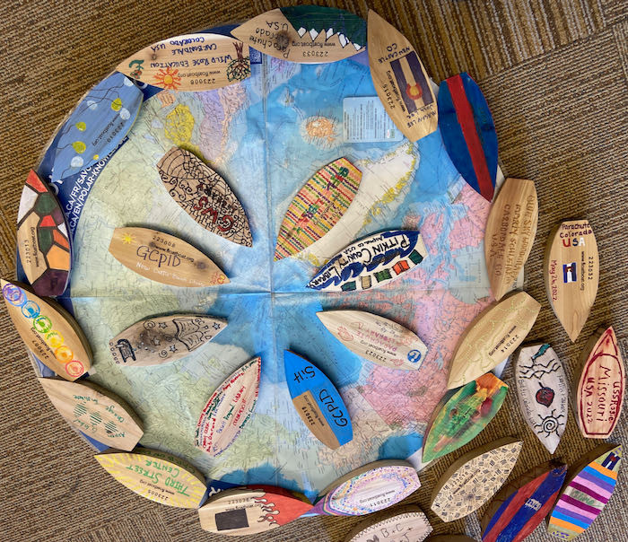 Decorated wooden boats on Arctic Ocean map