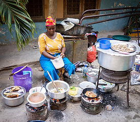 african-woman-cooking-traditional-food-street_21730-14543.webp