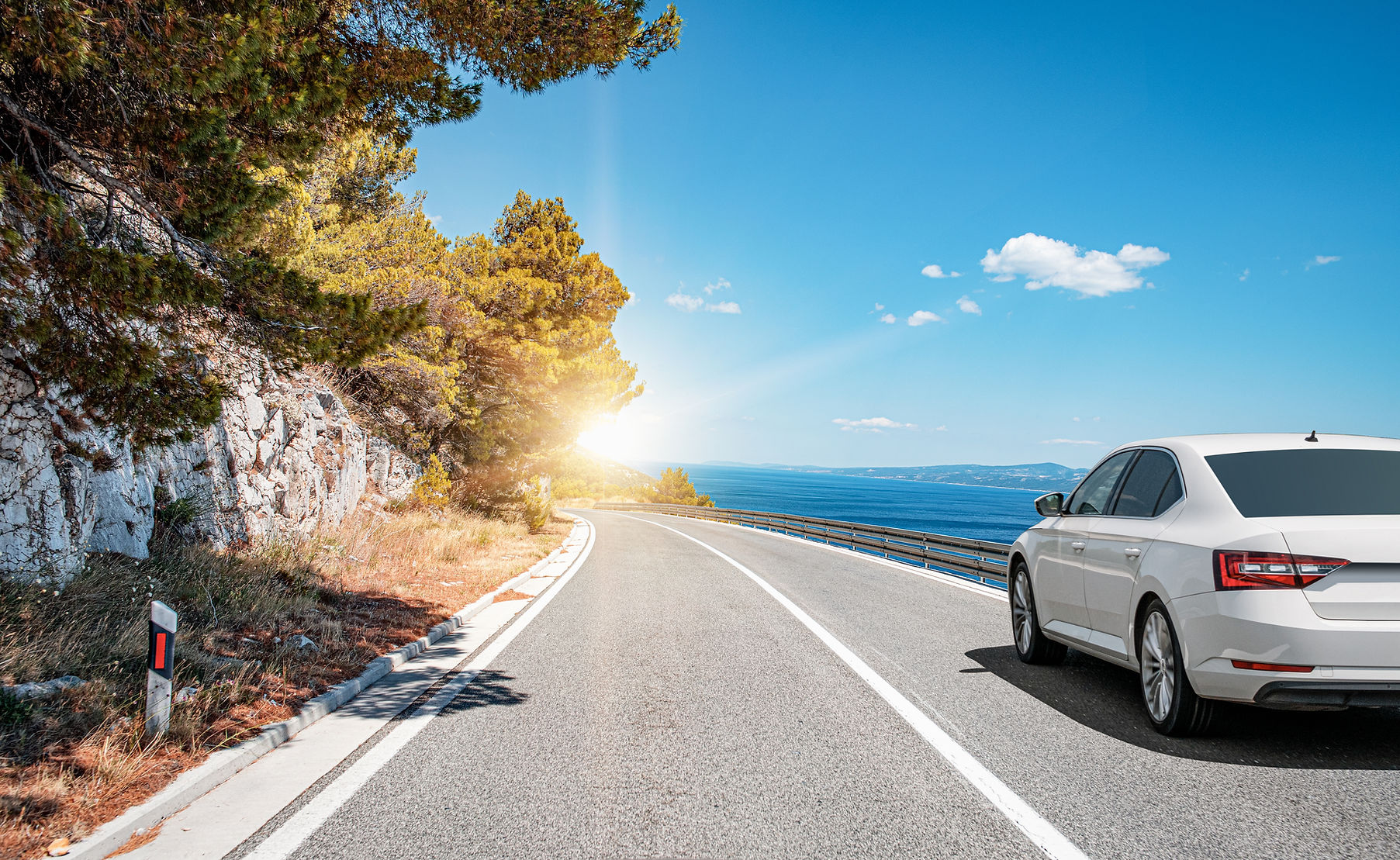 Car on the highway along the sea coast. Vacation or car rental concept..jpg