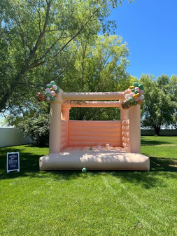 Pink 13x13 bouncy castle set amongst trees
