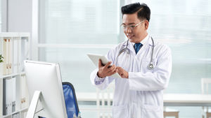 a doctor using a medical application on his digital device