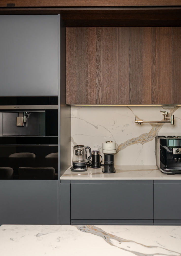 Pedini Arke beverage station with grey lacquer cabinetry, walnut veneer uppers, calacatta backsplash, and built-in ovens and coffee machines in a Coconut Grove Miami kitchen