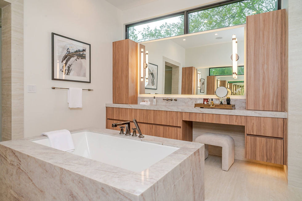 Primary bathroom with a wall hung wood texture vanity stepping down to a seated makeup position, full height wood volumes flanking the mirror under a clerestory window, and a stone wrapped tub. Pedini by Daruso, Pinecrest FL.