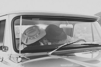 Western family photos, mom and dad kissing their child on the cheek, captured from outside their truck in scottsdale, arizona.