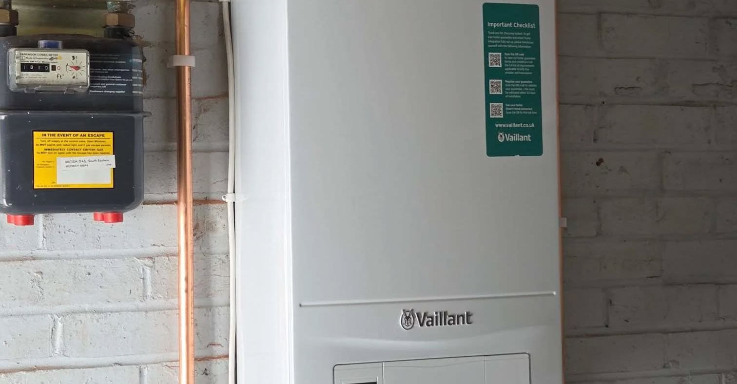 Professionally installed boiler with visible controls and neat pipework