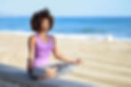 A woman practicing yoga in a serene outdoor setting
