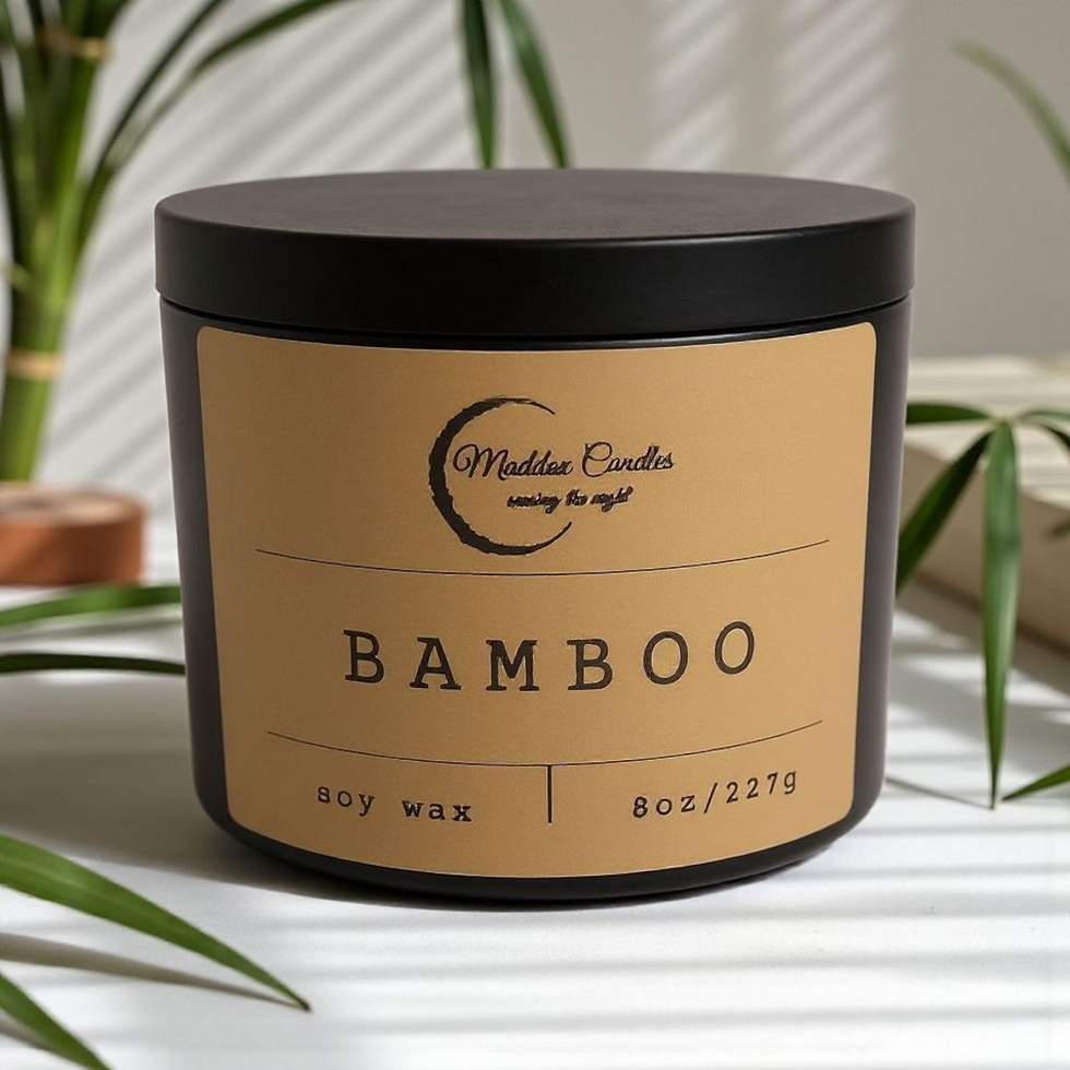 Bamboo soy wax candle with Maddox Candles branding amidst bamboo leaves.