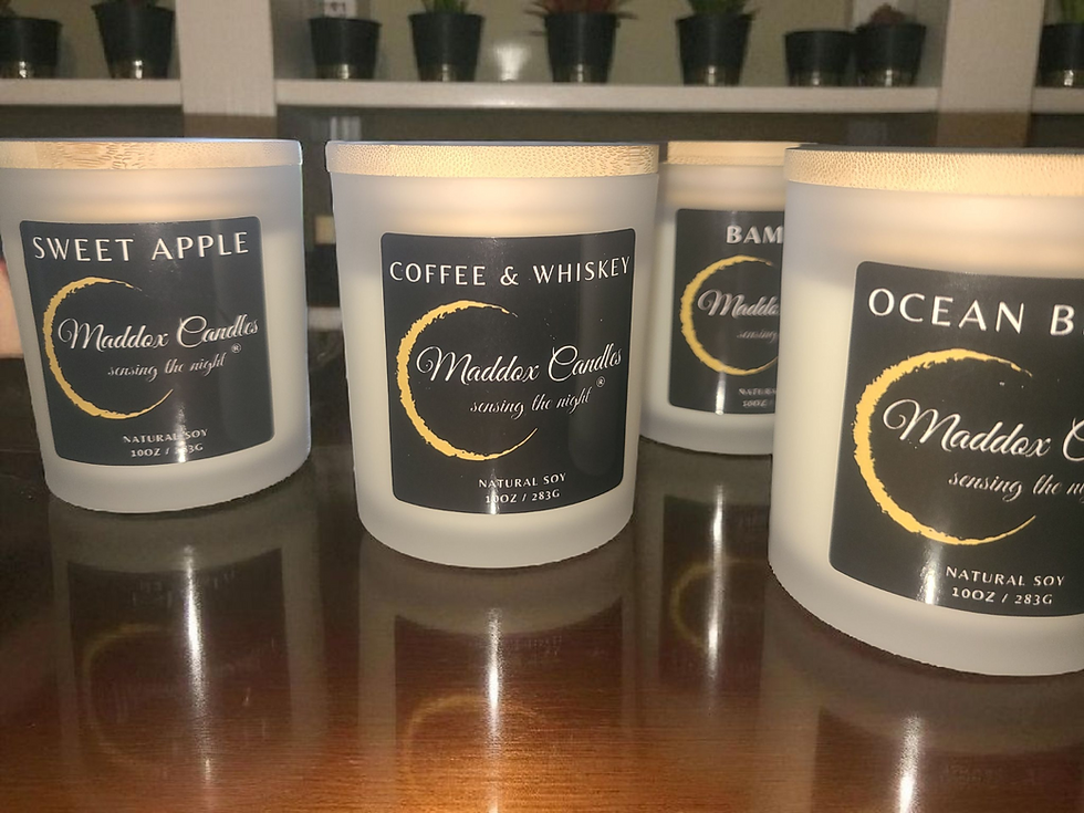 Eye-level view of a collection of soy candles with different scents on a wooden shelf
