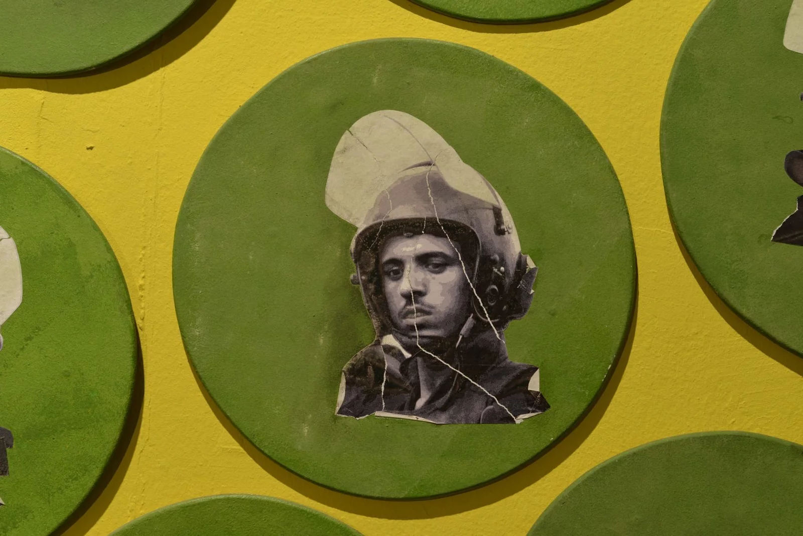 One circular mixed media portrait from Huda Lutfi’s “Portraits from Tahrir” series