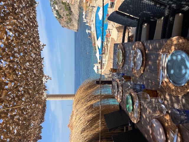 Restaurant at Gran Folies table in foreground, ocean in background