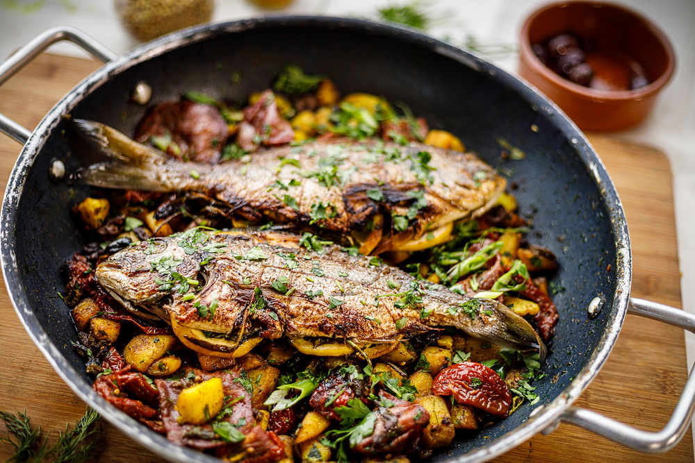 Two grilled fish with herbs and vegetables by Punk Chef