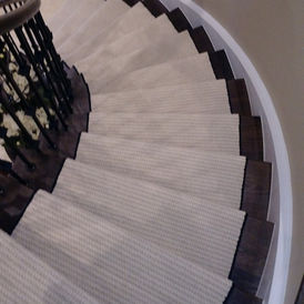 Stair runner on hardwood stairs, available at Direct Flooring Deals.